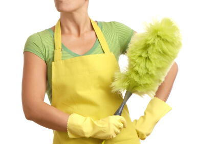 A woman holding a green feather duster